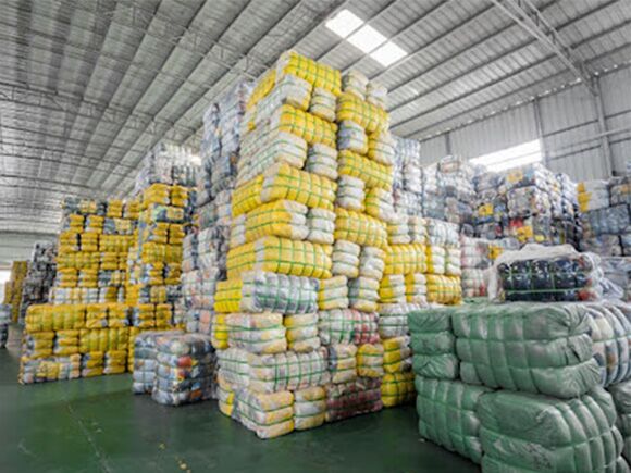 Bales of clothing in a factory